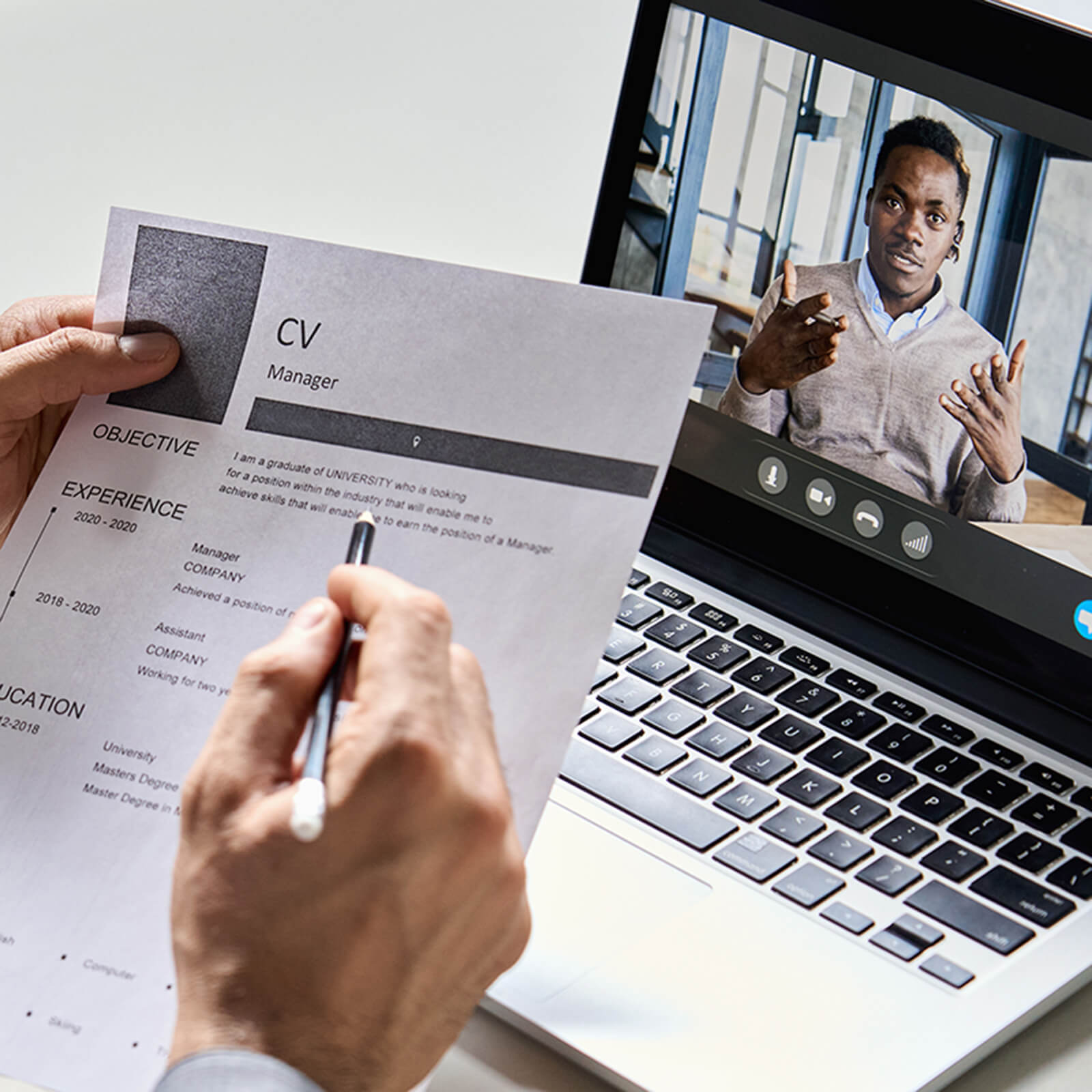 Hiring manager reviewing a resume with remote job candidate